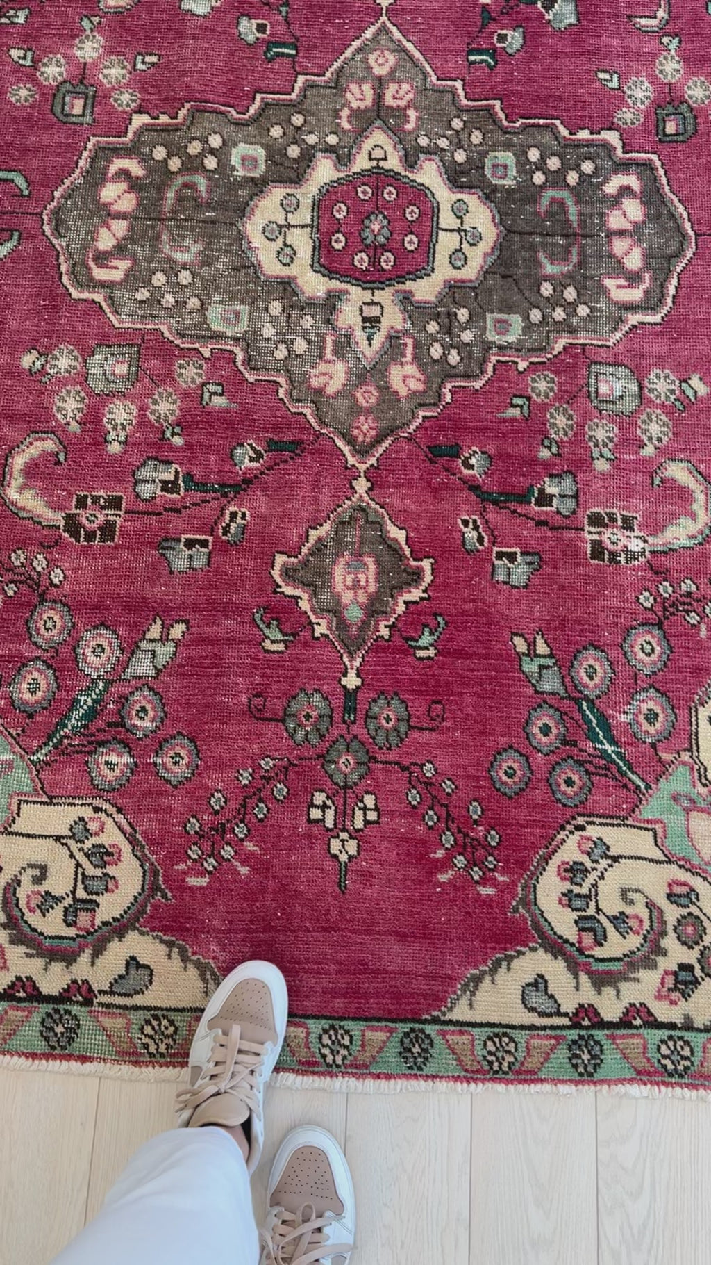 Close-up of Hand-Knotted Vintage Wool Area Rug – 7' 10" x 5' showing detailed floral motifs and rich red background with beige and green accents.