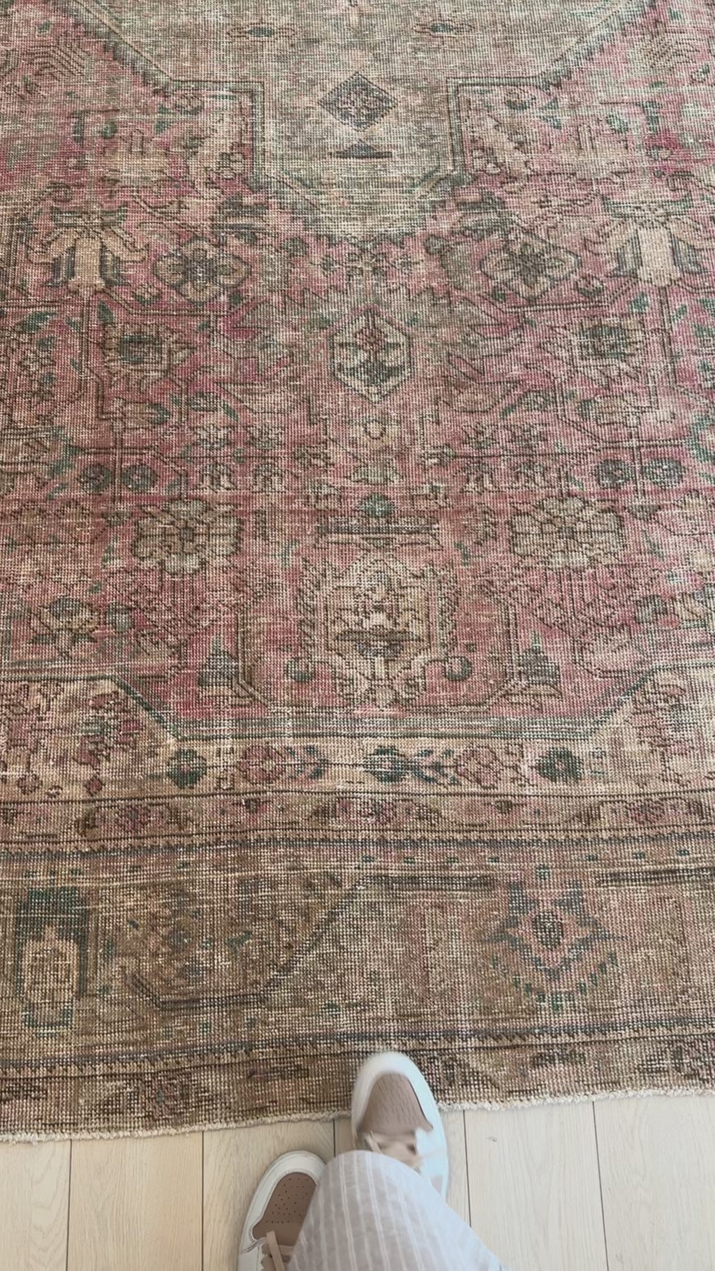 Close-up of the Hand-Knotted Vintage Large Wool Area Rug Faded – 12' 9" x 9' 10" highlighting detailed motifs and worn texture in pink and earthy tones.