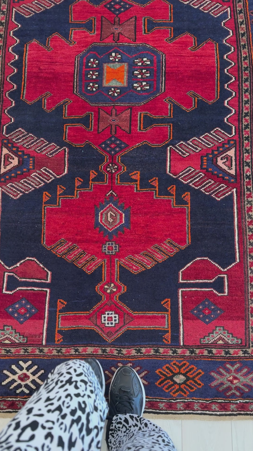 Close-up view of Hand-Knotted Vintage Wool Area Rug – 7' 3" x 4' 3" showing detailed geometric motifs and rich red and navy hues.